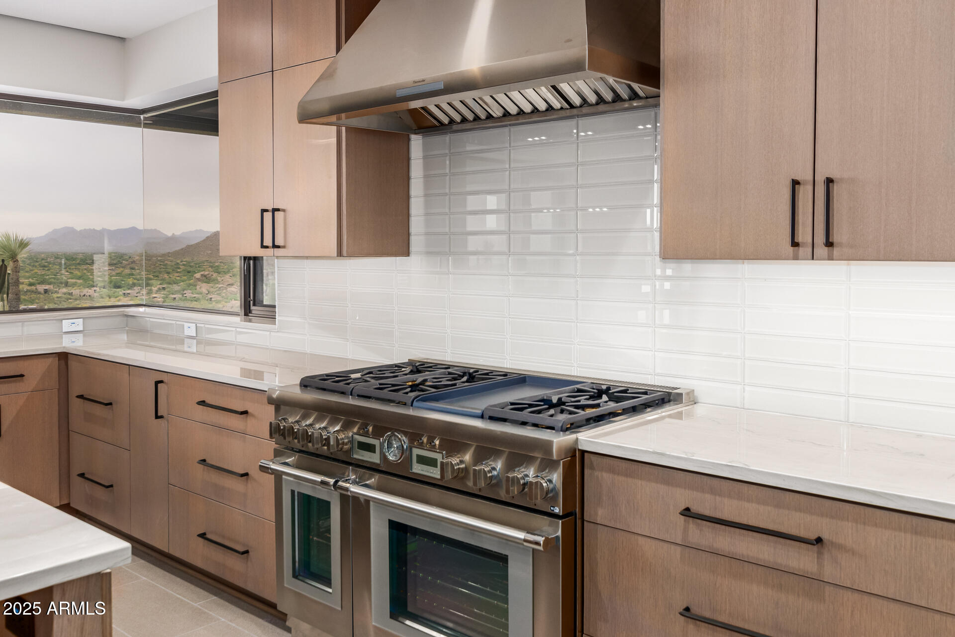 6901 East Restin Road Carefree, AZ 85377 - Photo 15 of 59 a kitchen with granite countertop a stove and a sink