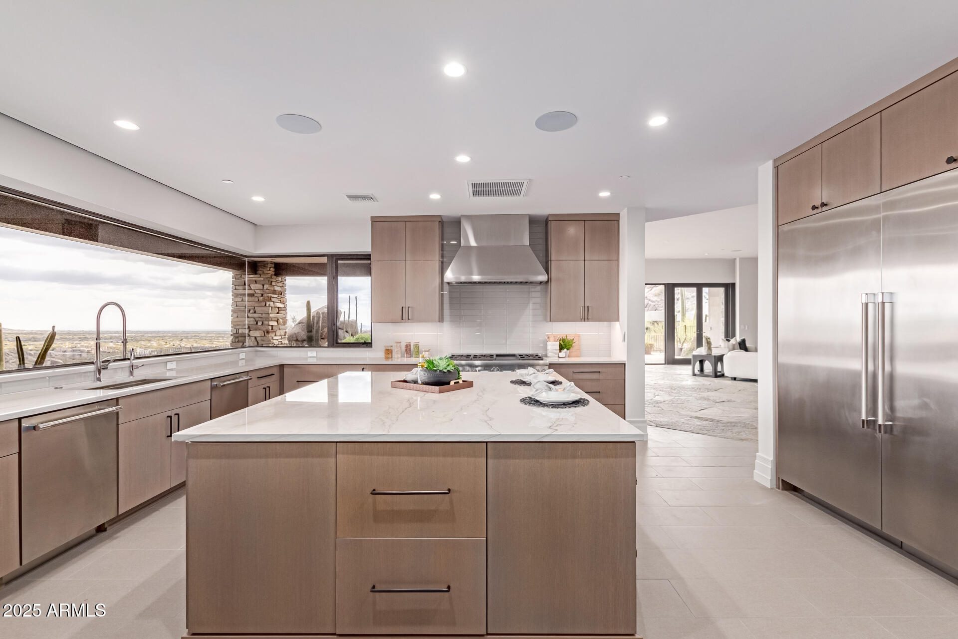 6901 East Restin Road Carefree, AZ 85377 - Photo 16 of 59 a kitchen with counter top space sink and center island