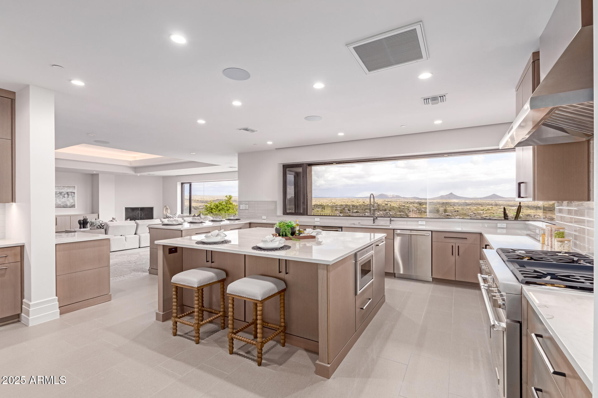 6901 East Restin Road Carefree, AZ 85377 - Photo 18 of 59 a kitchen with a sink stove and white cabinets