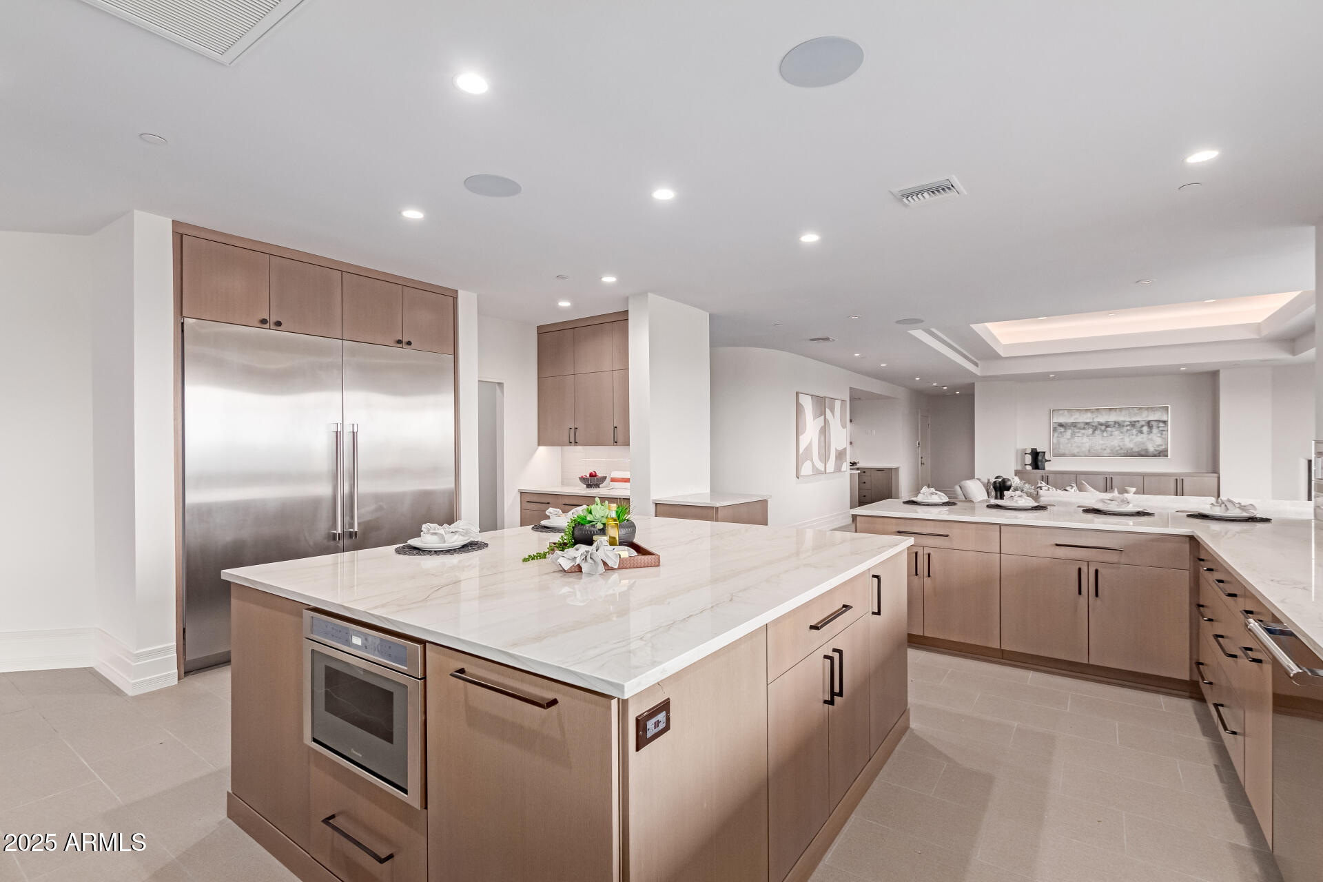 6901 East Restin Road Carefree, AZ 85377 - Photo 19 of 59 a kitchen that has a lot of cabinets in it and wooden floor