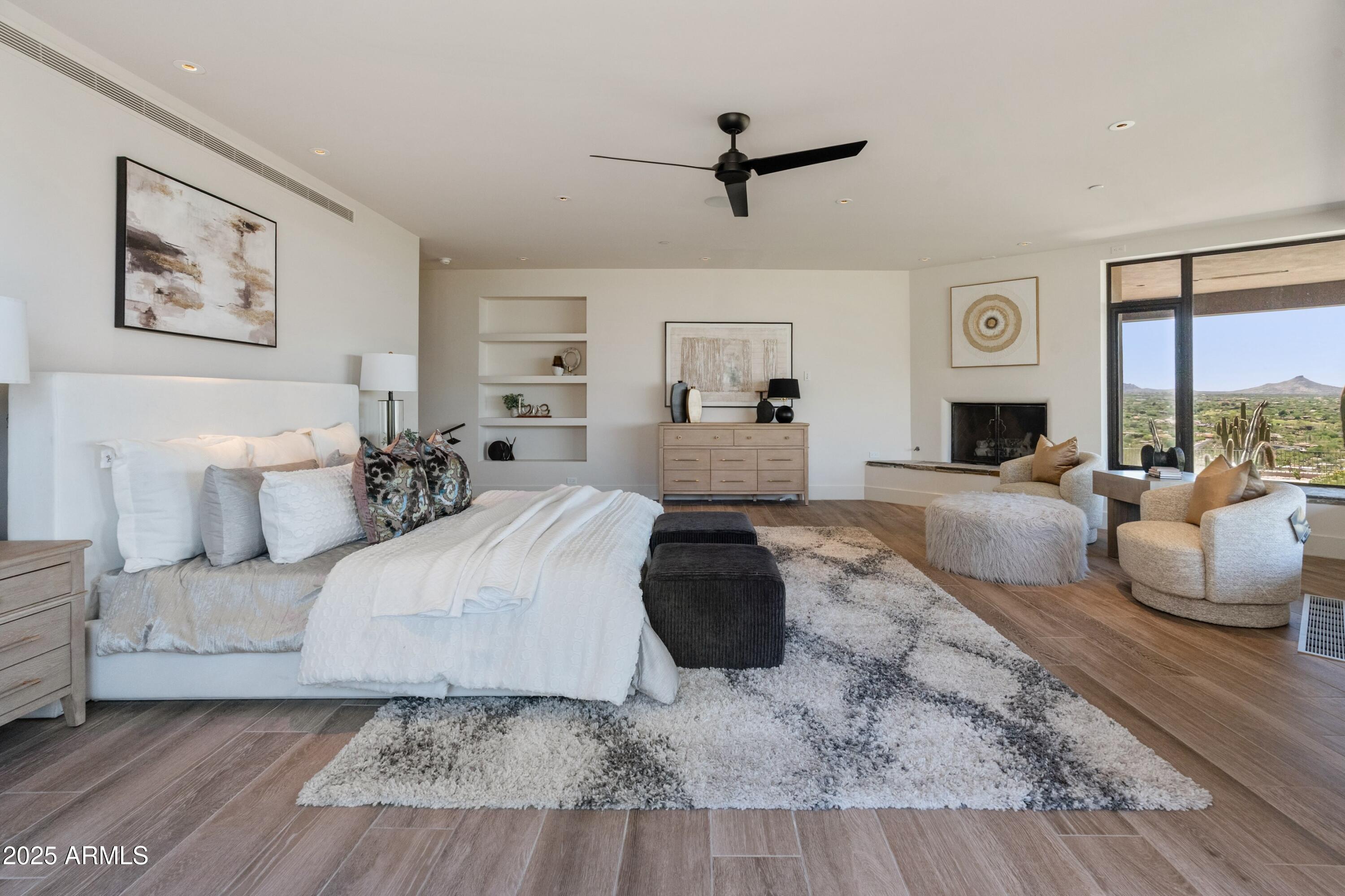 6901 East Restin Road Carefree, AZ 85377 - Photo 24 of 59 a bedroom with a large bed and a chandelier
