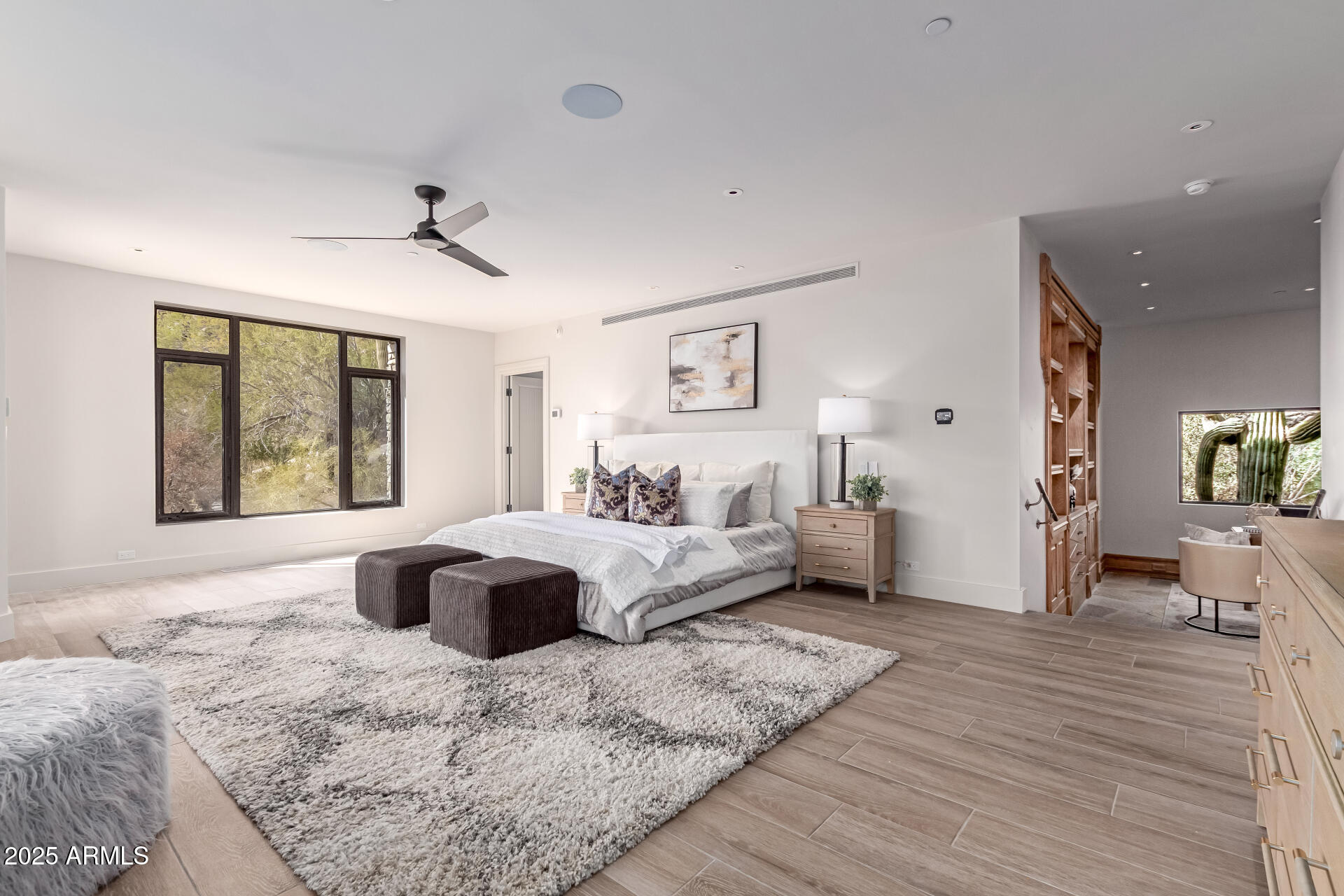 6901 East Restin Road Carefree, AZ 85377 - Photo 27 of 59 a large bedroom with a large bed and windows