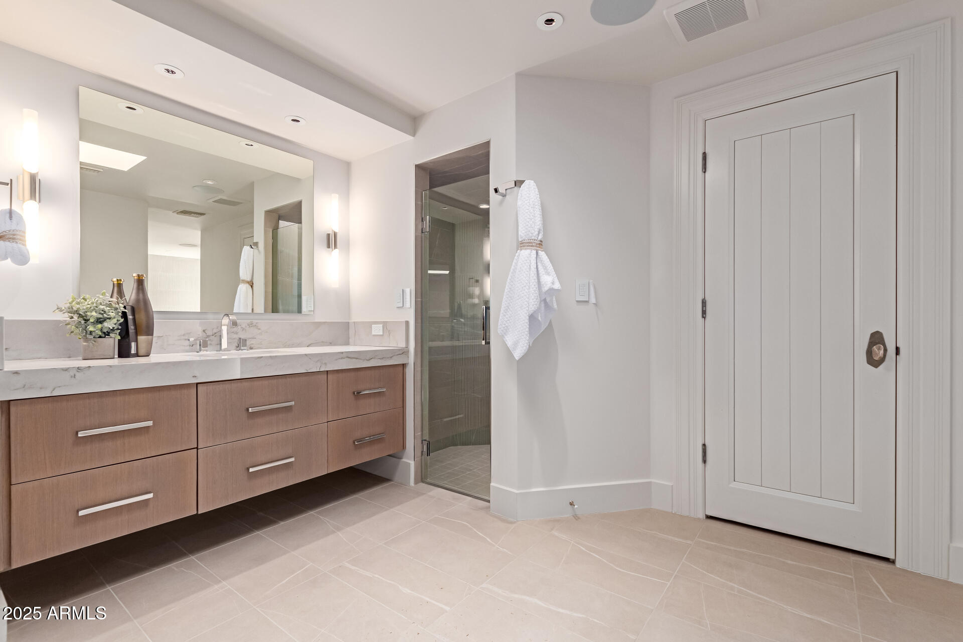 6901 East Restin Road Carefree, AZ 85377 - Photo 32 of 59 a spacious bathroom with a double vanity sink a mirror and a shower