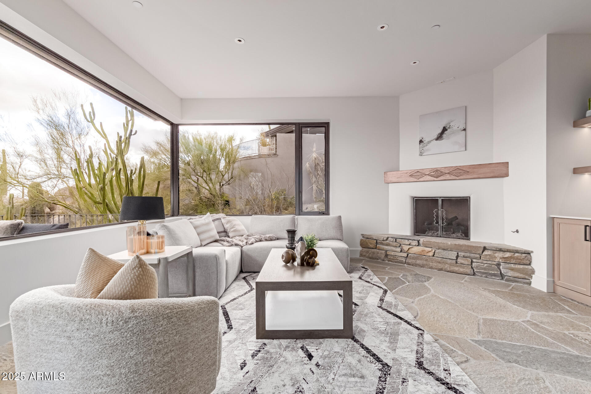 6901 East Restin Road Carefree, AZ 85377 - Photo 39 of 59 a living room with furniture large window and a fireplace
