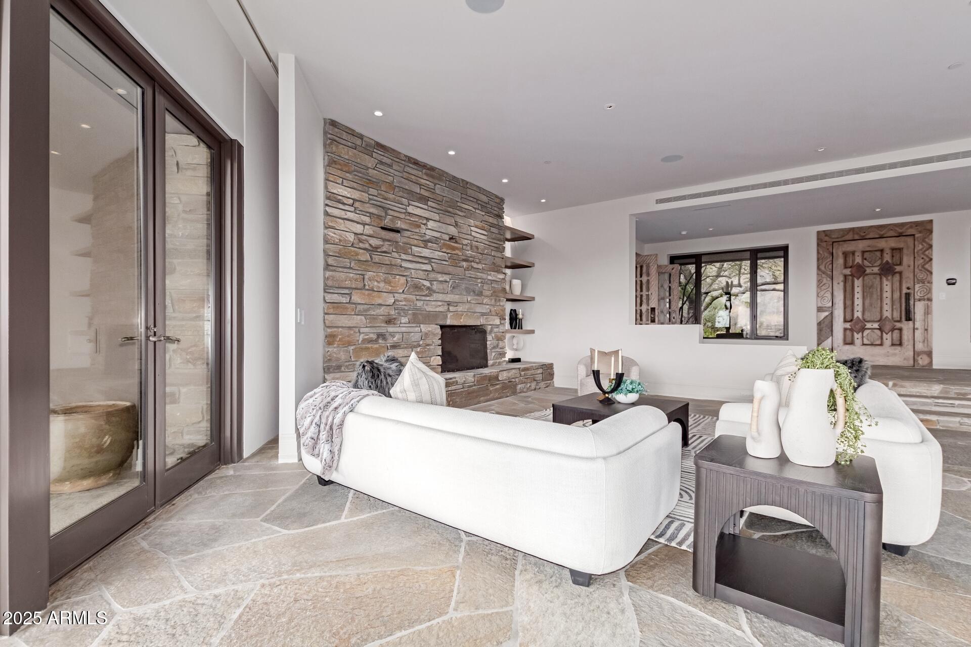 6901 East Restin Road Carefree, AZ 85377 - Photo 9 of 59 a living room with furniture a fireplace and a flat screen tv