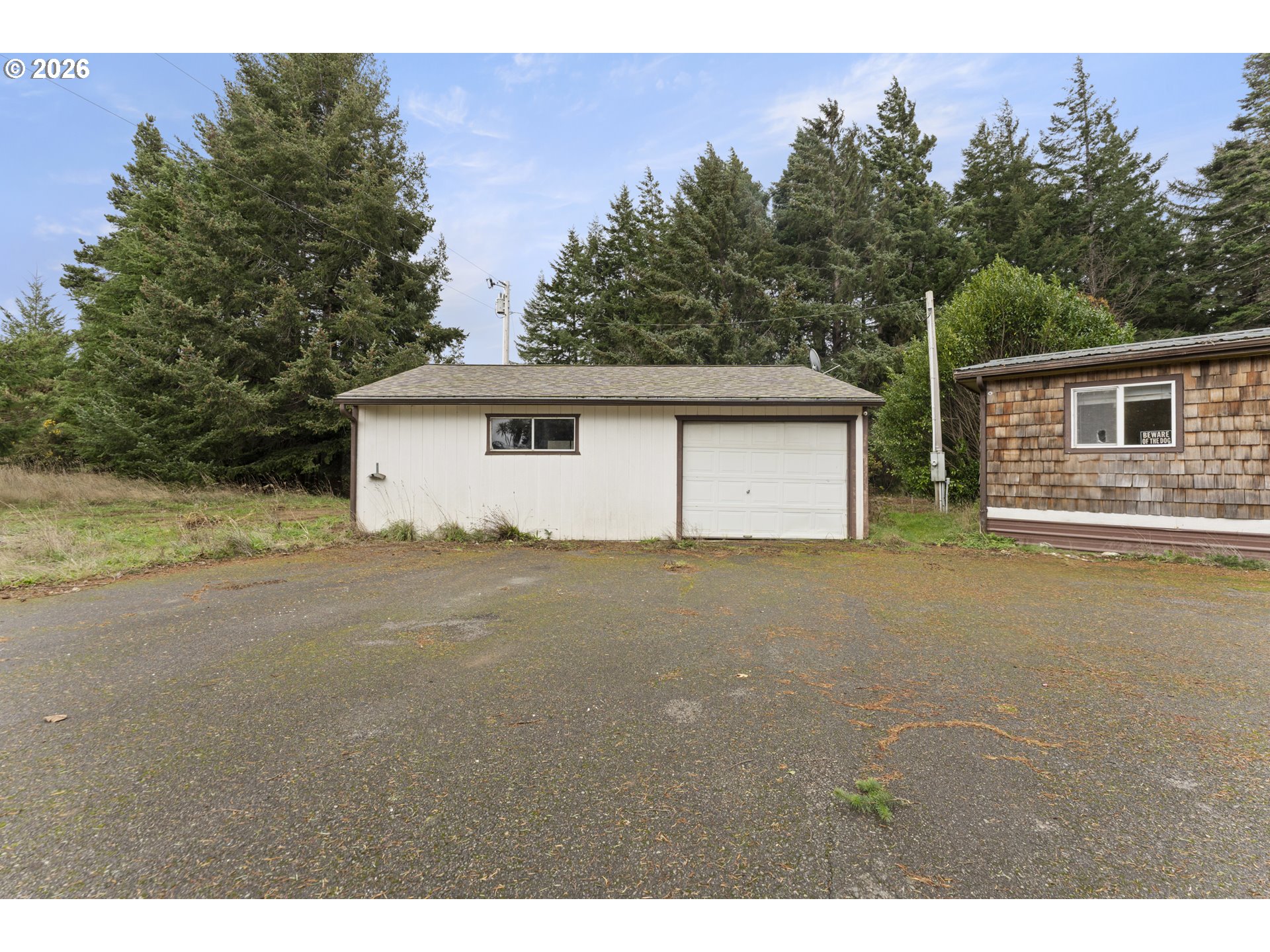 53665 Rosa Road Bandon, OR 97411 - Photo 28 of 47 a view of a house with a outdoor space and balcony