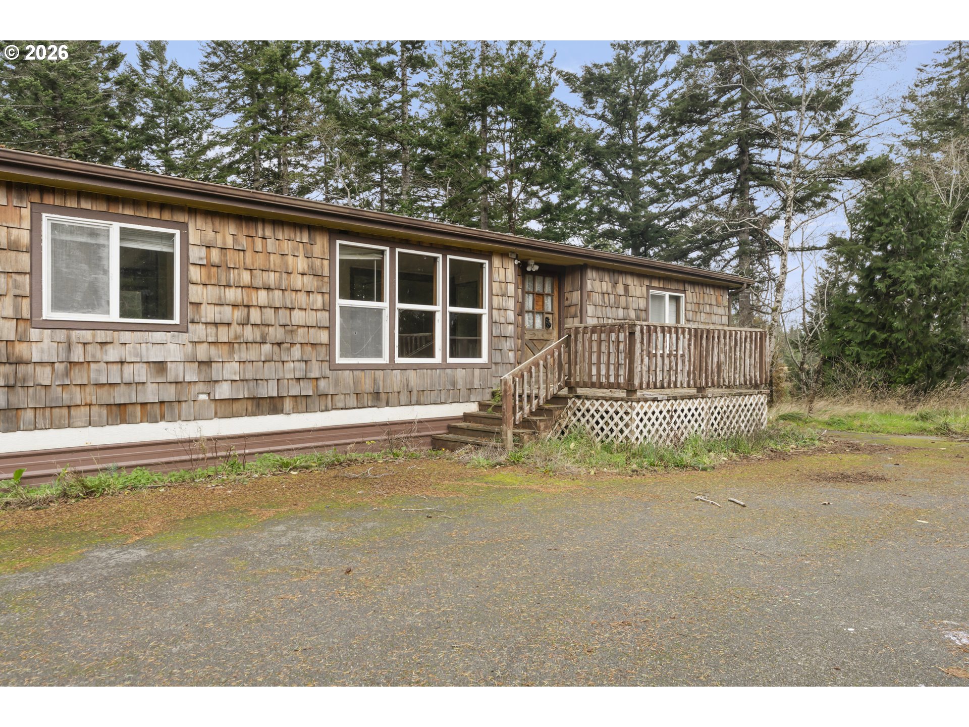 53665 Rosa Road Bandon, OR 97411 - Photo 29 of 47 a view of a house with a yard and sitting area