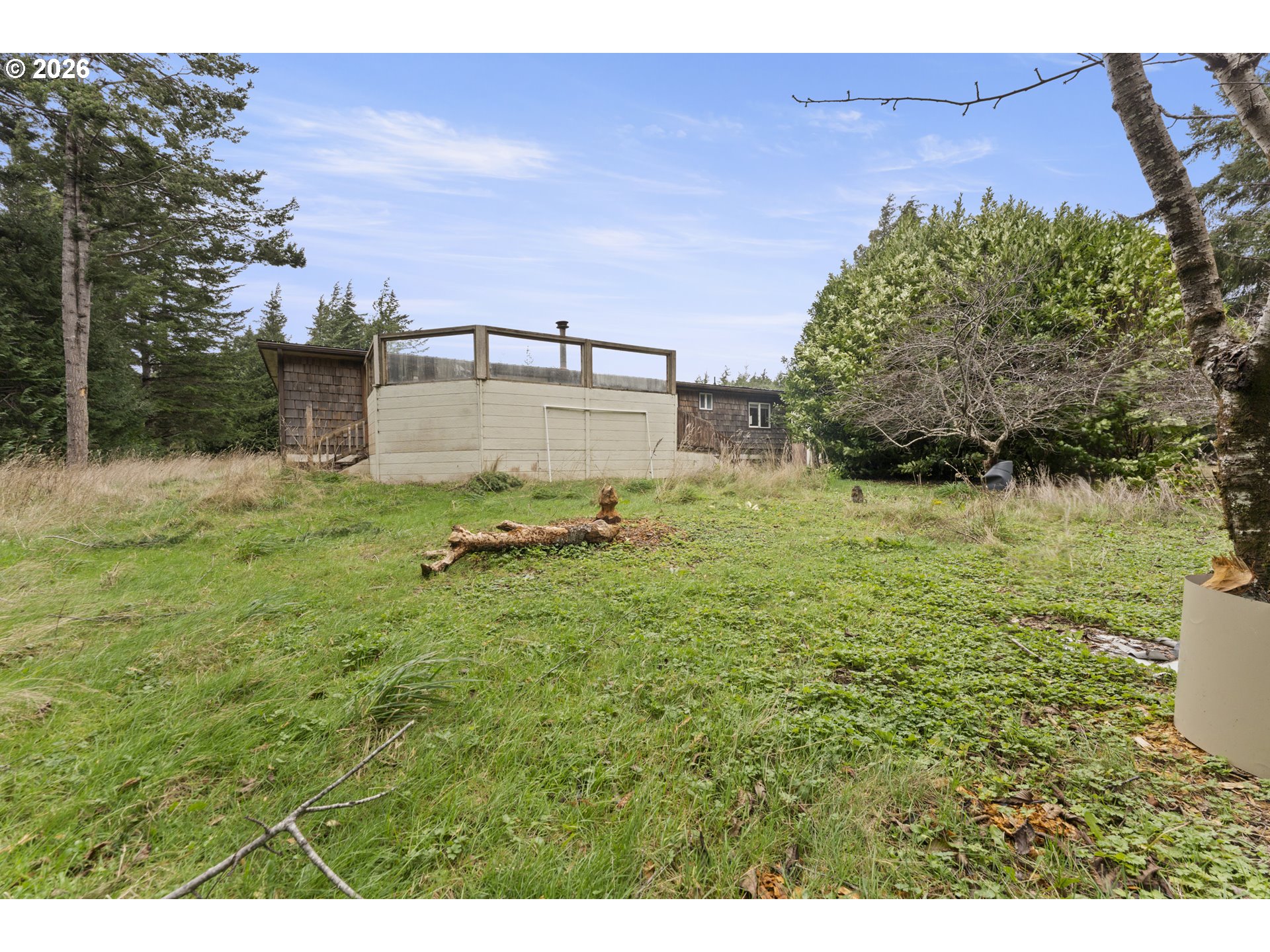 53665 Rosa Road Bandon, OR 97411 - Photo 45 of 47 a view of a garden with a building in the background