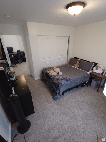 552 Sunset Crest Way Draper, UT 84020 - Photo 36 of 68 Bedroom with a desk, a closet, carpet flooring, and a textured ceiling