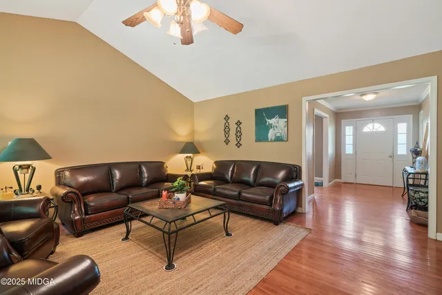 a living room with furniture and a wooden floor