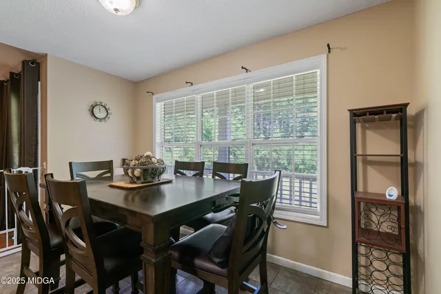 a view of a dining room with furniture and window