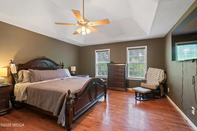 a bedroom with a bed a couch and dresser