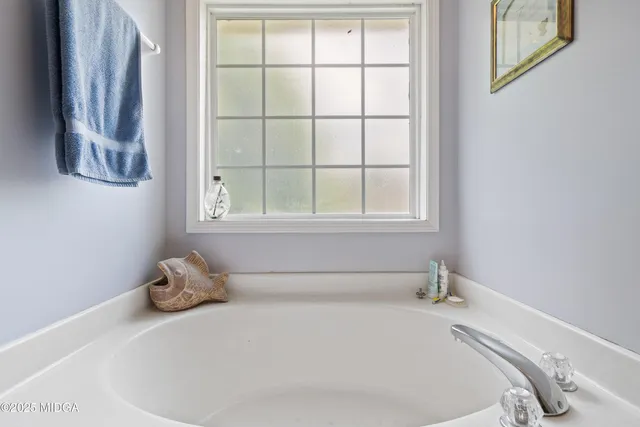 a white bath tub sitting next to a window