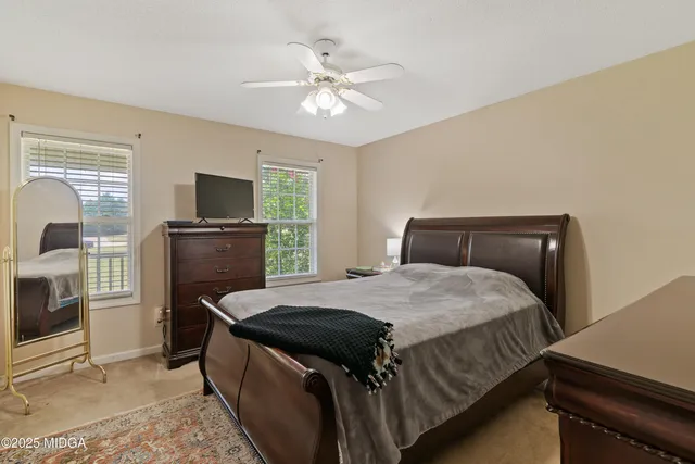 a bedroom with a bed and a television