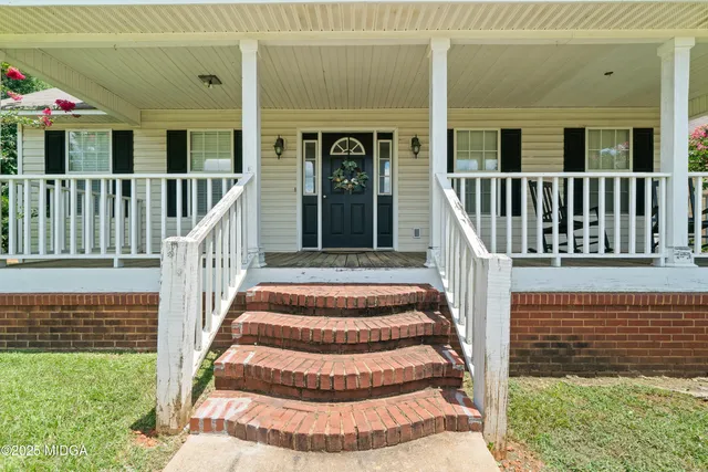 a view of front door of house with stairs