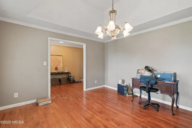 a view of a workspace with furniture and a chandelier