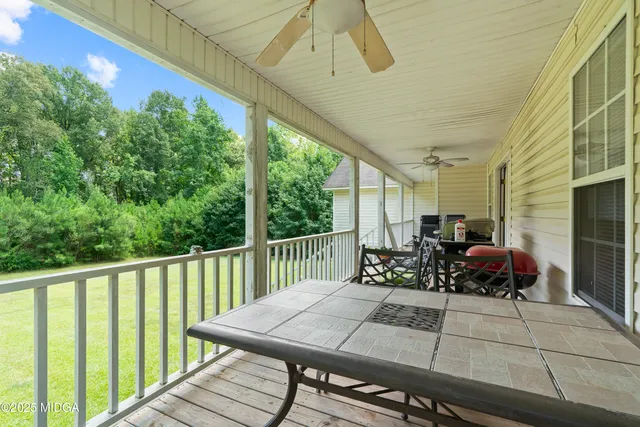 a view of a patio with table and chairs and wooden floor