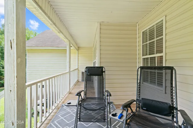 a view of balcony with two chairs and stairs