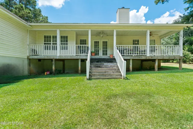 a view of a house with a yard and sitting area