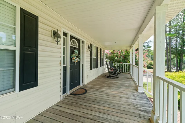 a view of a balcony with wooden floor