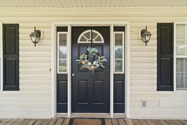 a front view of a house with a potted plant