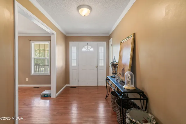 a view of an entryway with wooden floor