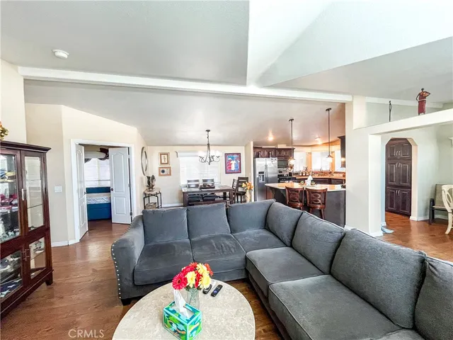 a living room with furniture and a view of kitchen