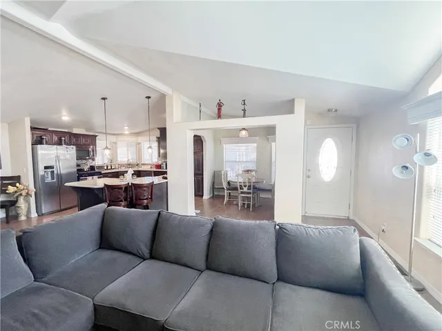 a living room with furniture and view of kitchen
