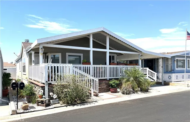 a view of a house with a small yard and plants