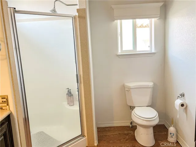 a bathroom with a toilet and a shower