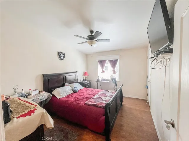 a bedroom with bed and a chandelier