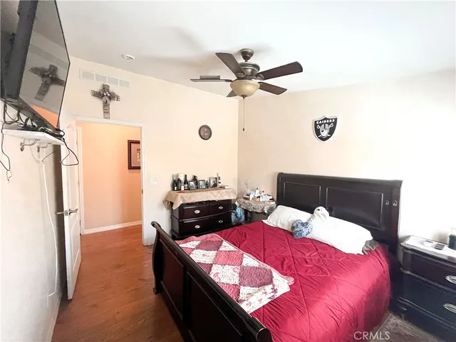 a bedroom with a bed and a refrigerator