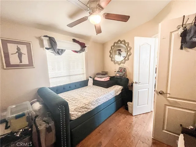 a bedroom with a bed and wooden floor