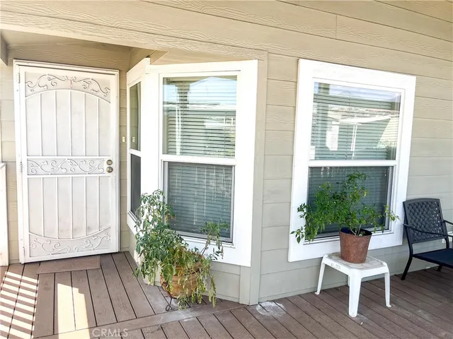 a view of a room that has a window and wooden floor