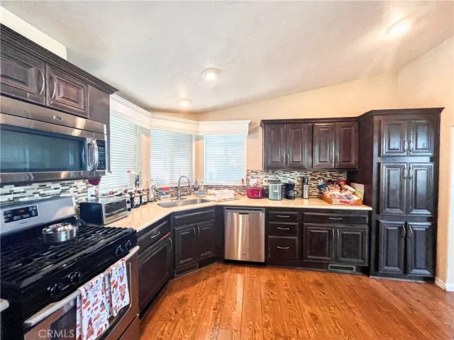 a kitchen with stainless steel appliances granite countertop a stove and a sink