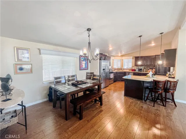 a living room with furniture and a dining table with kitchen view