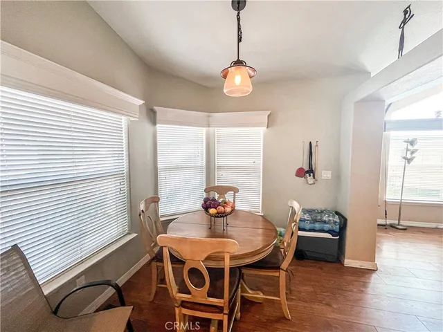 a view of a dining room with furniture and window