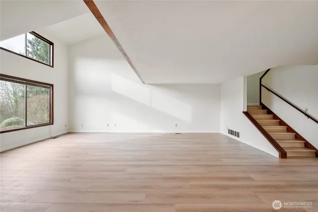 a view of a room with wooden walls and windows