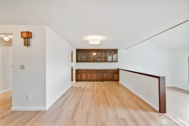a view of a room with wooden floor and a bathroom