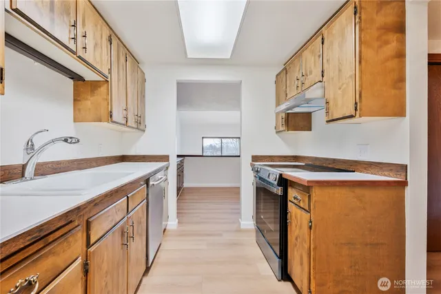 a utility room with cabinets washer and dryer