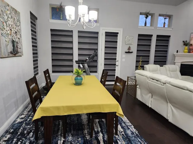 a view of a dining room with furniture and a window