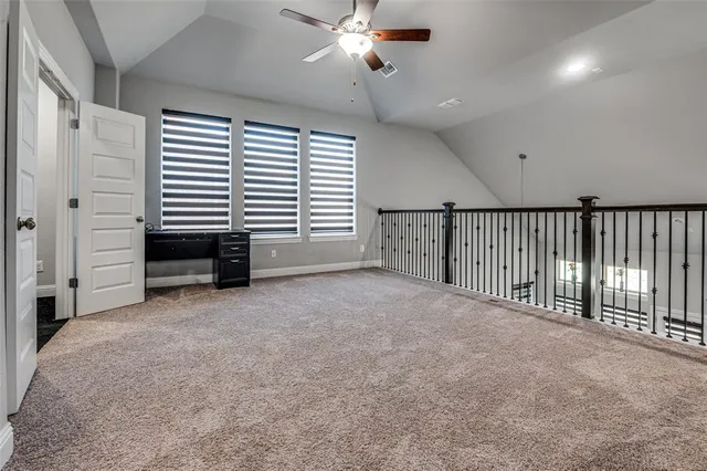 a view of a livingroom with a ceiling fan and window