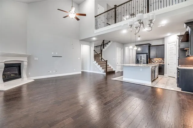 a kitchen with stainless steel appliances granite countertop a sink window and wooden floor