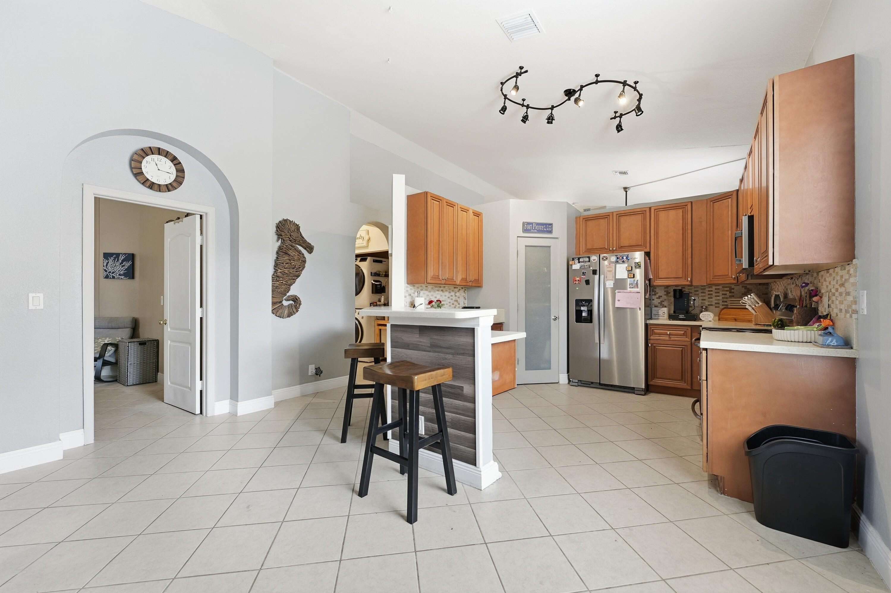 6117 Spring Lake Terrace Fort Pierce, FL 34951 - Photo 13 of 38 a kitchen with refrigerator cabinets and chair