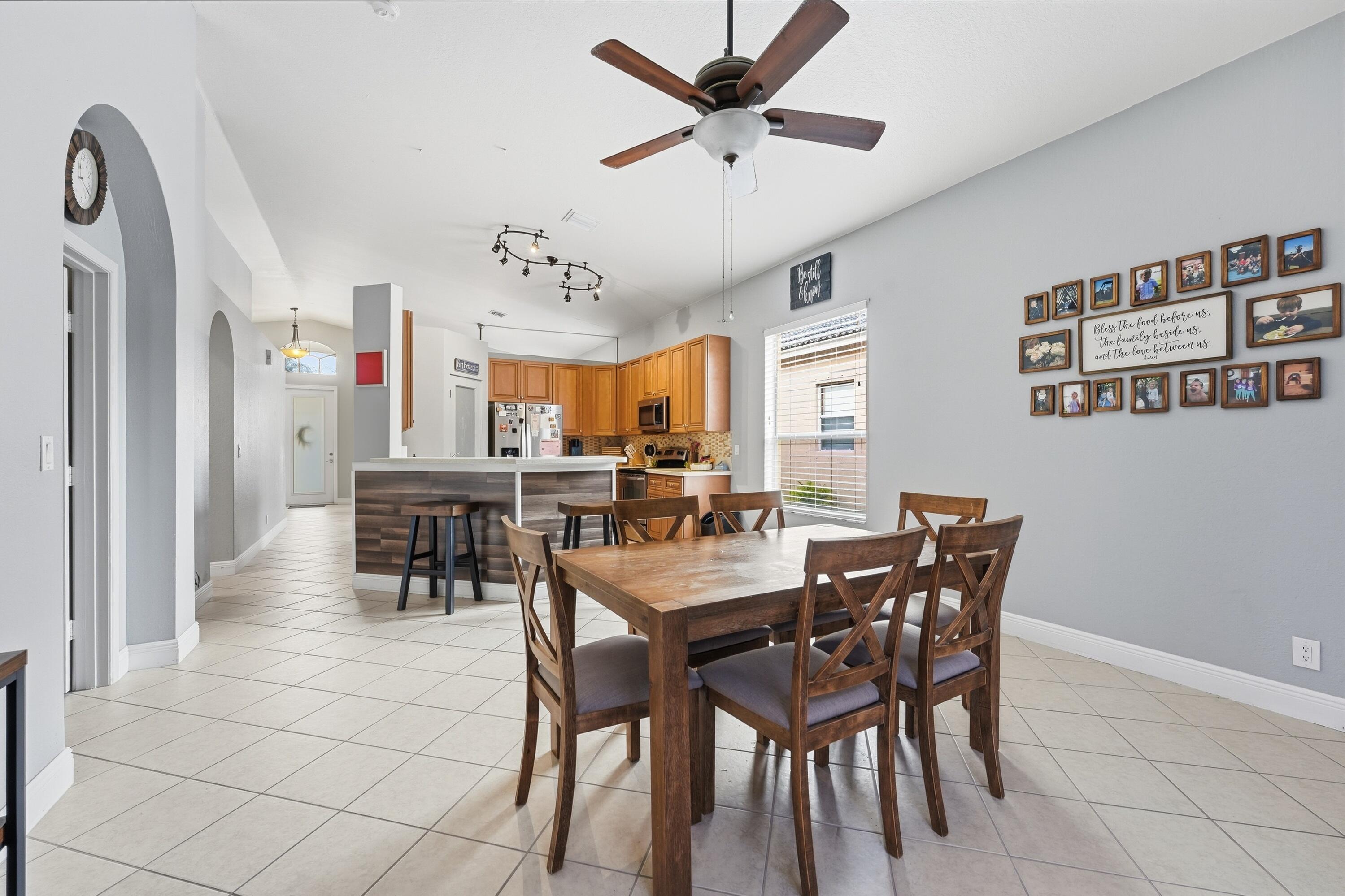 6117 Spring Lake Terrace Fort Pierce, FL 34951 - Photo 17 of 38 a view of a dining room and livingroom with furniture a rug a painting and a chandelier
