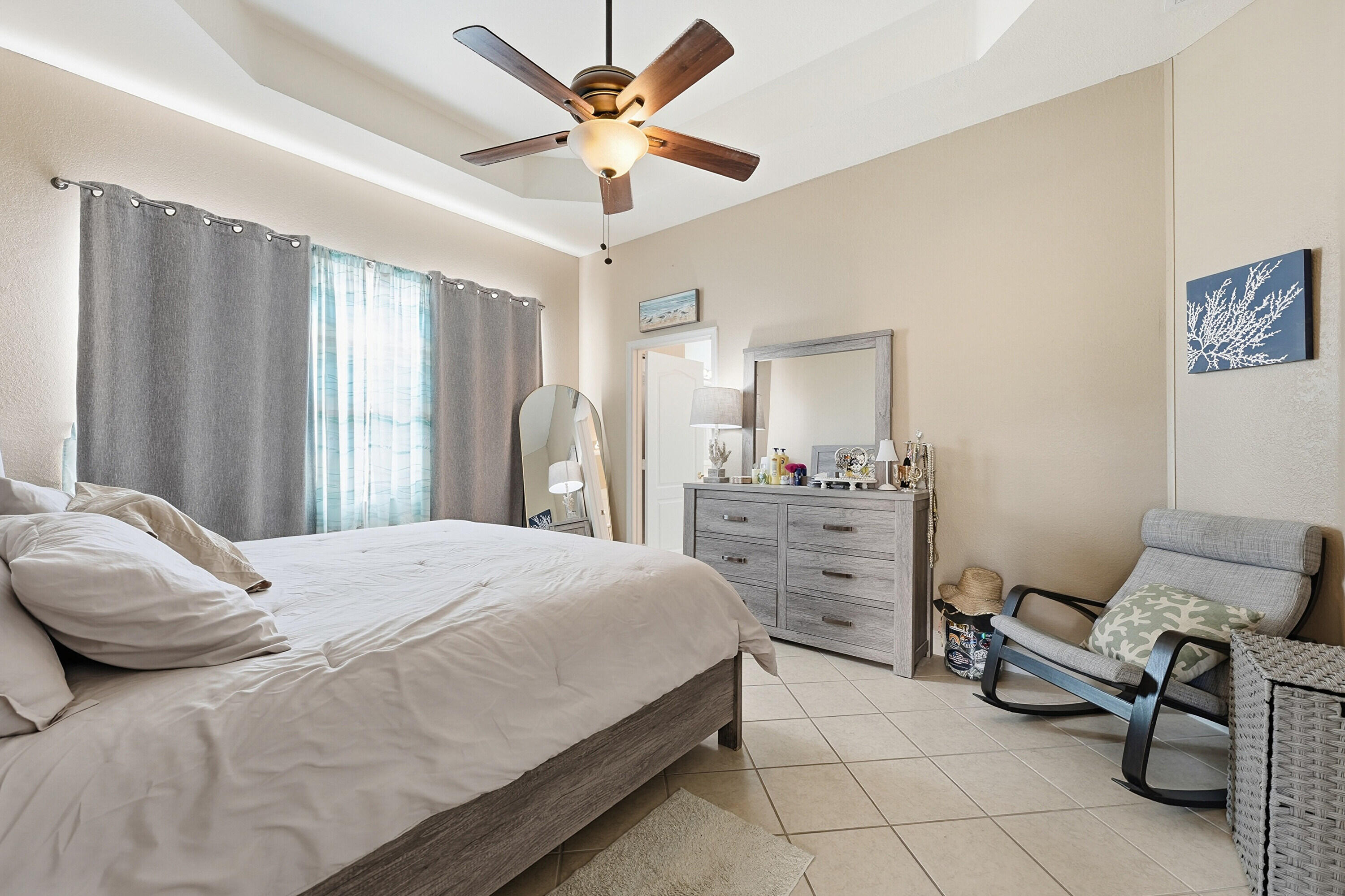 6117 Spring Lake Terrace Fort Pierce, FL 34951 - Photo 19 of 38 a bedroom with a bed and a chandelier