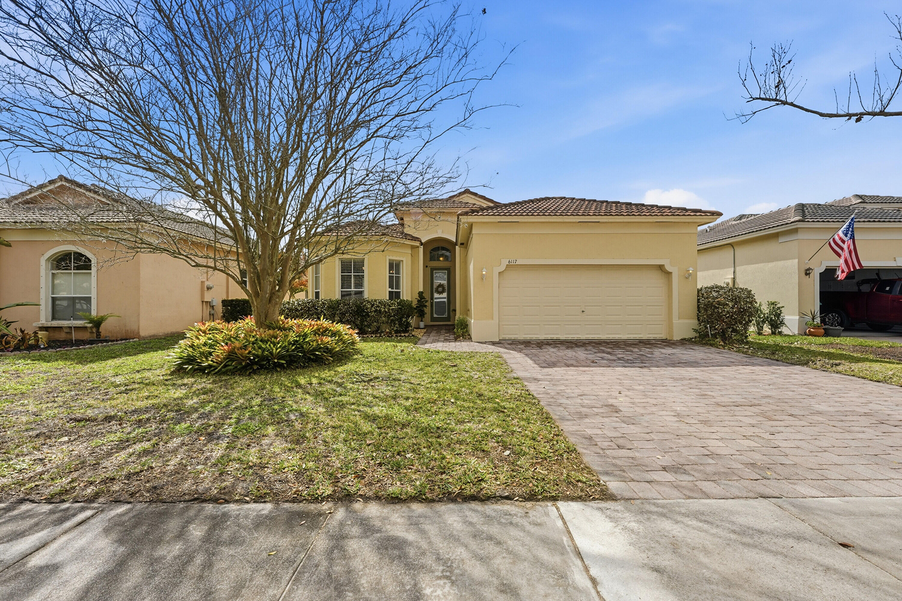 6117 Spring Lake Terrace Fort Pierce, FL 34951 - Photo 2 of 38 a front view of a house with a yard and garage