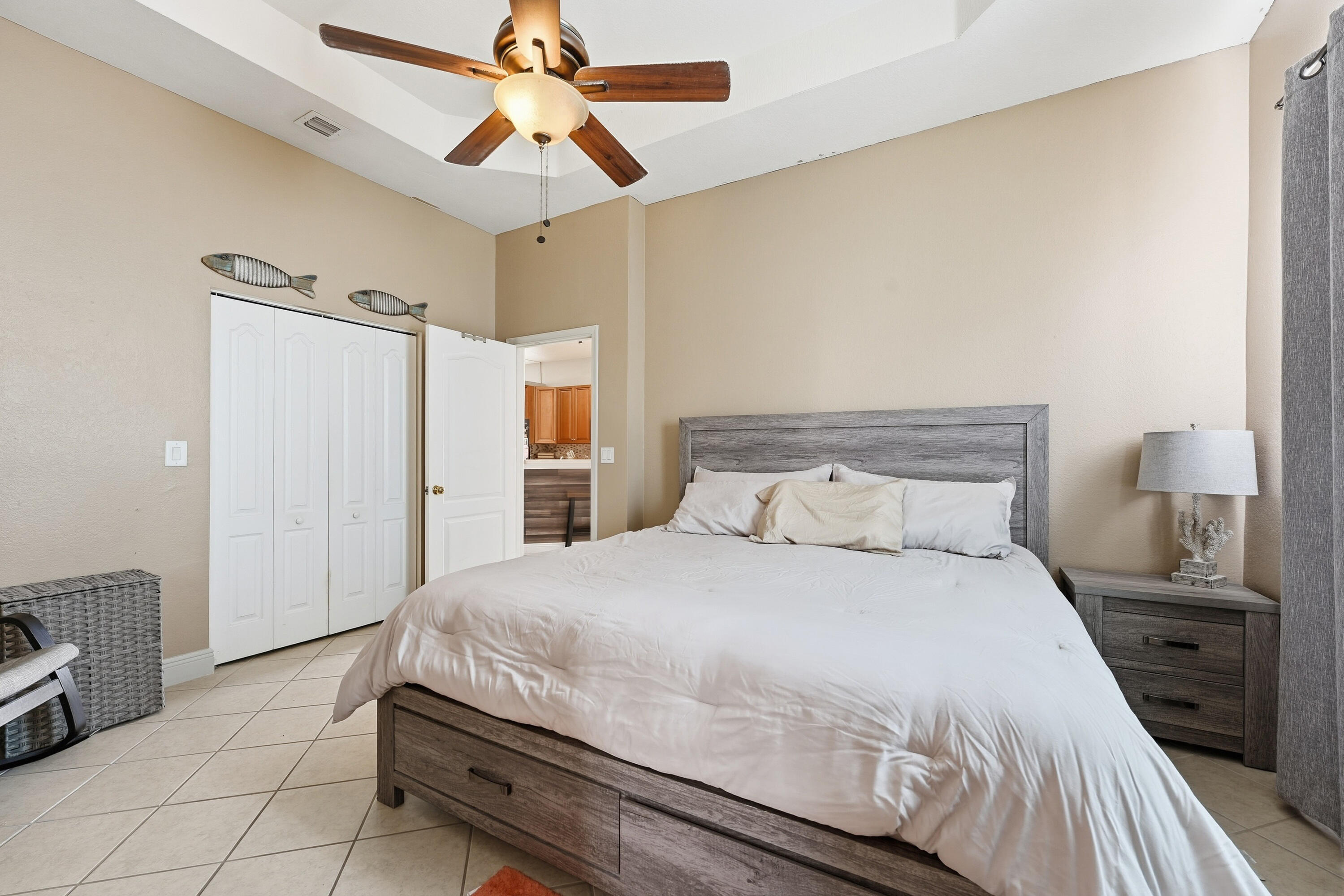 6117 Spring Lake Terrace Fort Pierce, FL 34951 - Photo 21 of 38 a bedroom with a bed and a chandelier