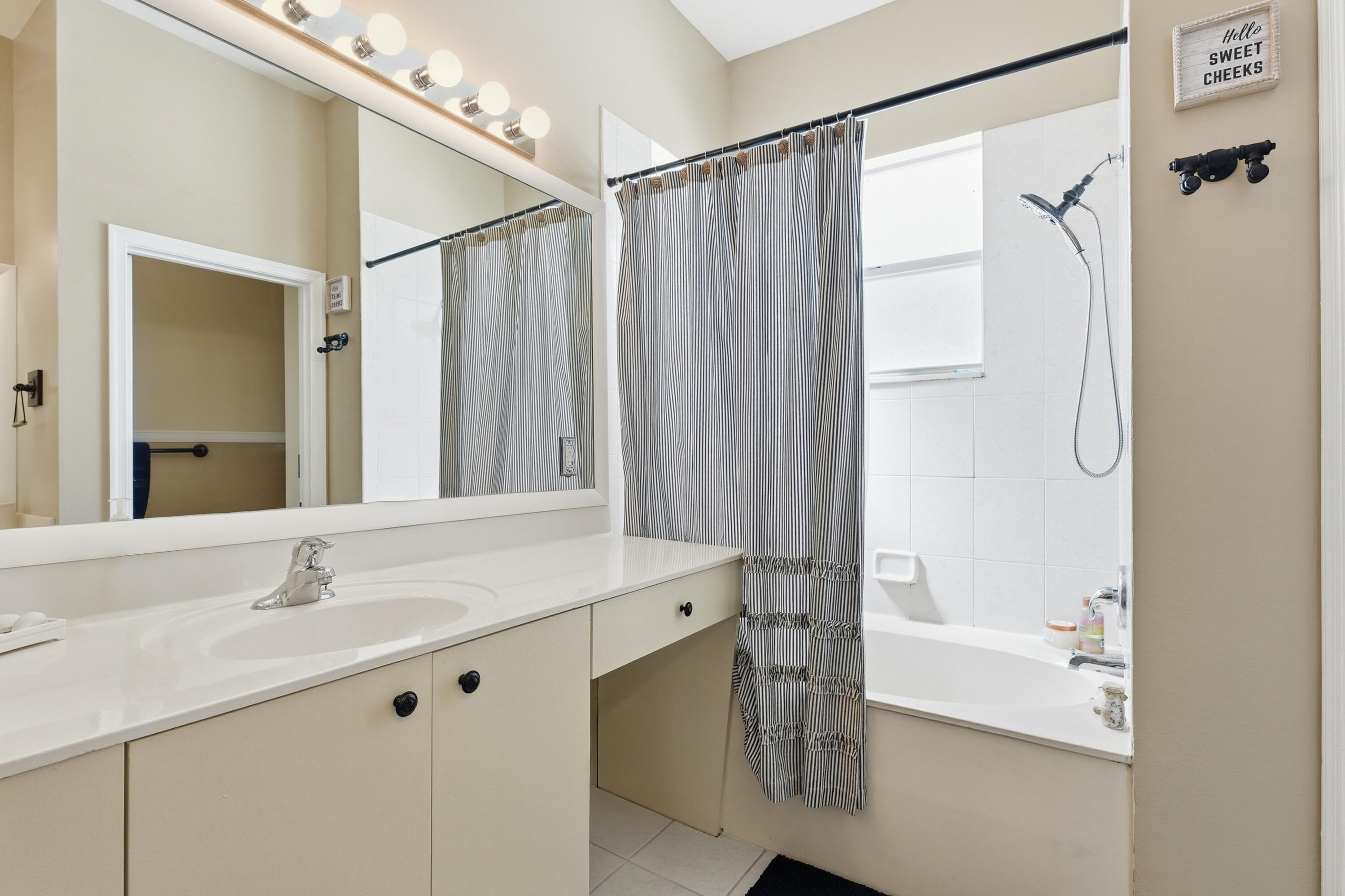 6117 Spring Lake Terrace Fort Pierce, FL 34951 - Photo 23 of 38 a bathroom with a shower sink and mirror