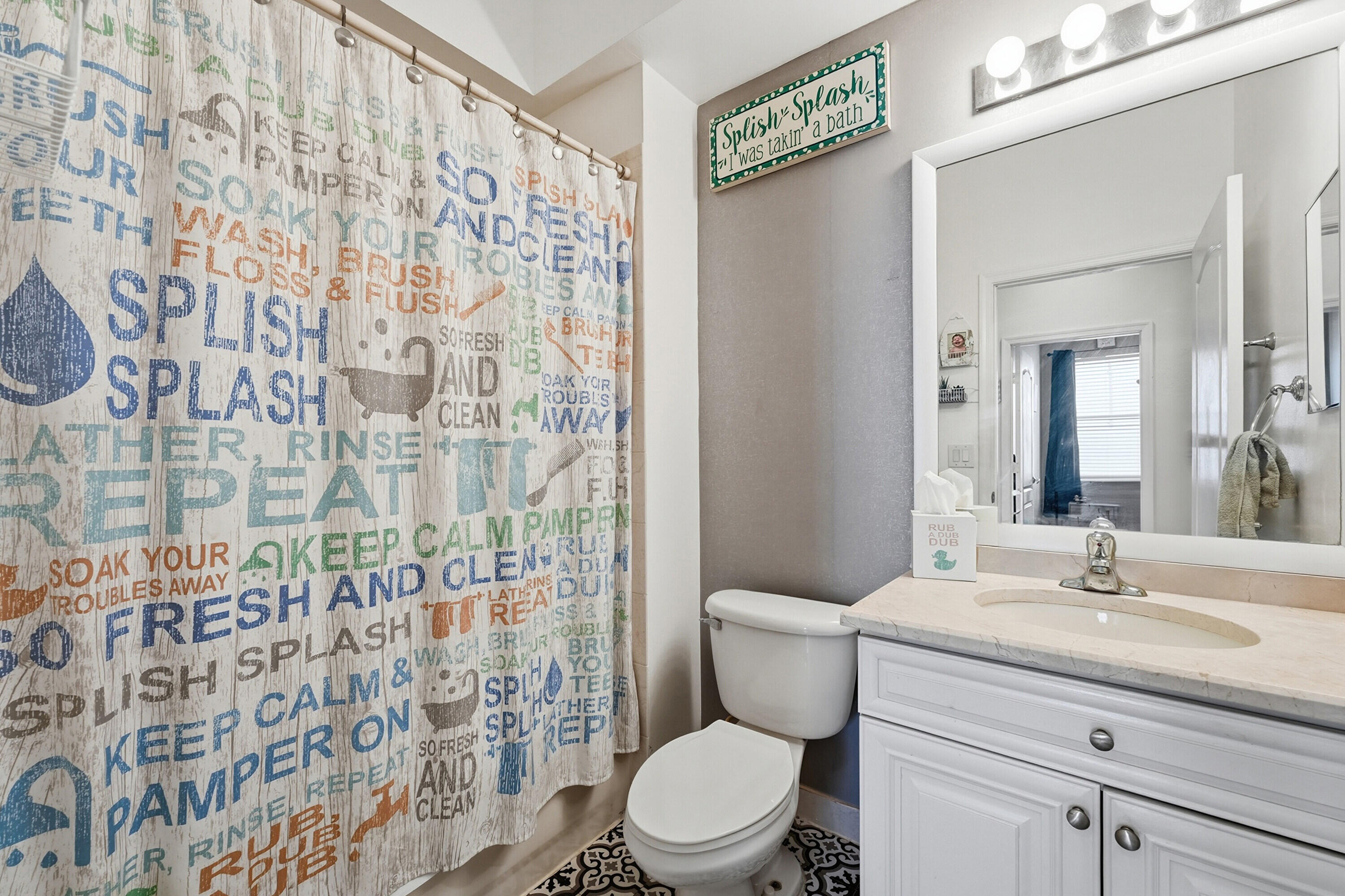 6117 Spring Lake Terrace Fort Pierce, FL 34951 - Photo 30 of 38 a bathroom with a sink a toilet and shower curtain